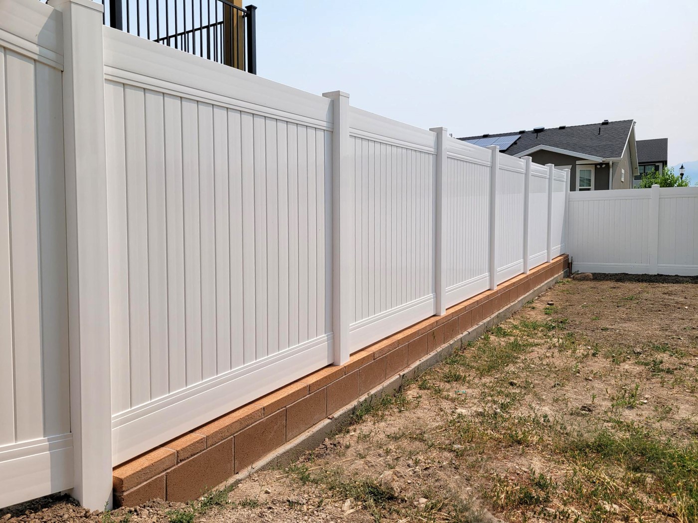 Vinyl Fence on Geneva Brown Block Wall